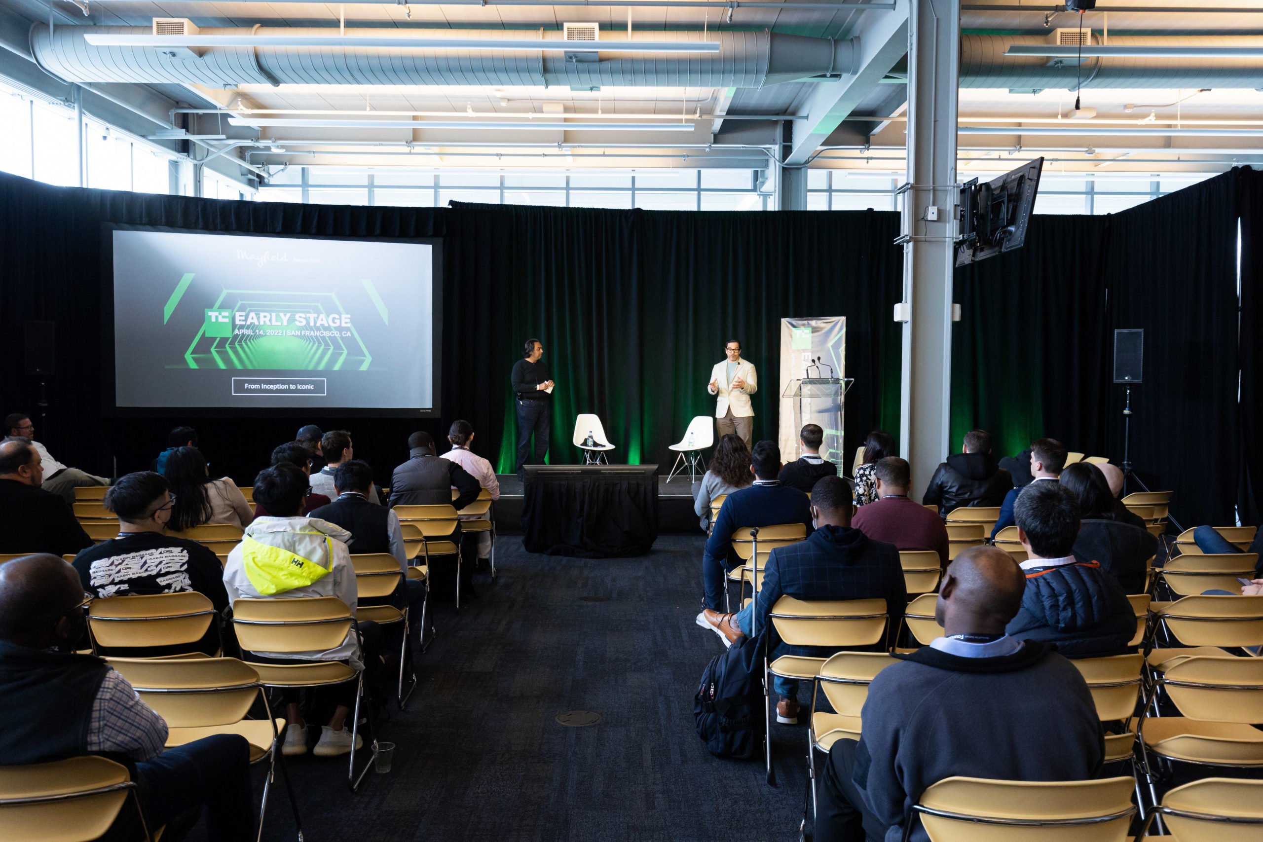 Rajeev Batra and Manny Medina standing on the stage in front of audience at TechCrunch Early Stage